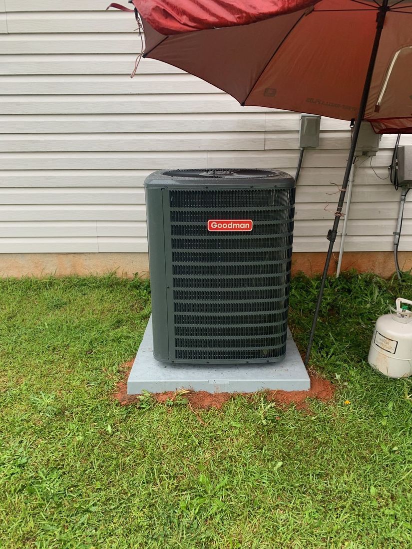 Outdoor condenser unit set on a new pad